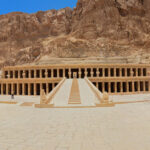 The Mortuary Temple of Hatshepsut at Deir el-Bahari, with its multi-tiered colonnaded design blending into the surrounding cliffs.
