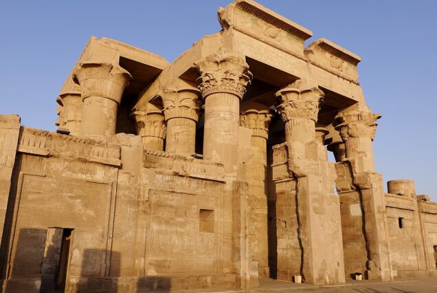 "Temple of Kom Ombo in Upper Egypt, featuring dual entrances and sanctuaries dedicated to Sobek and Haroeris, with hypostyle hall columns."