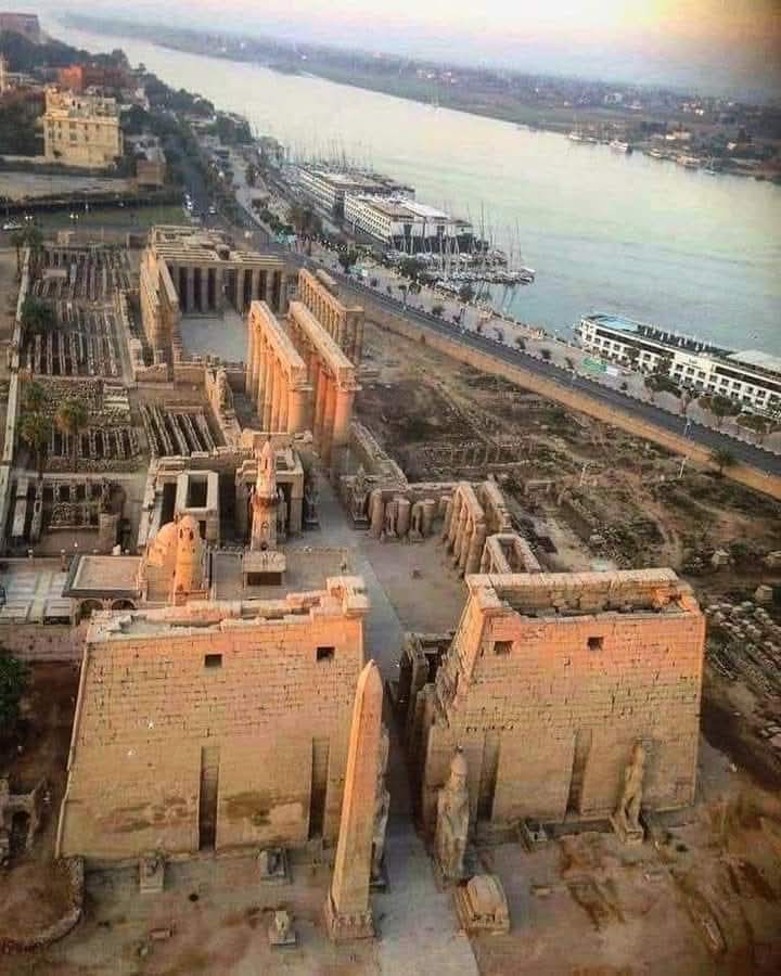 "Aerial view of Luxor Temple on the east bank of the Nile in Luxor, Egypt, showing monumental pylons and temple structures."