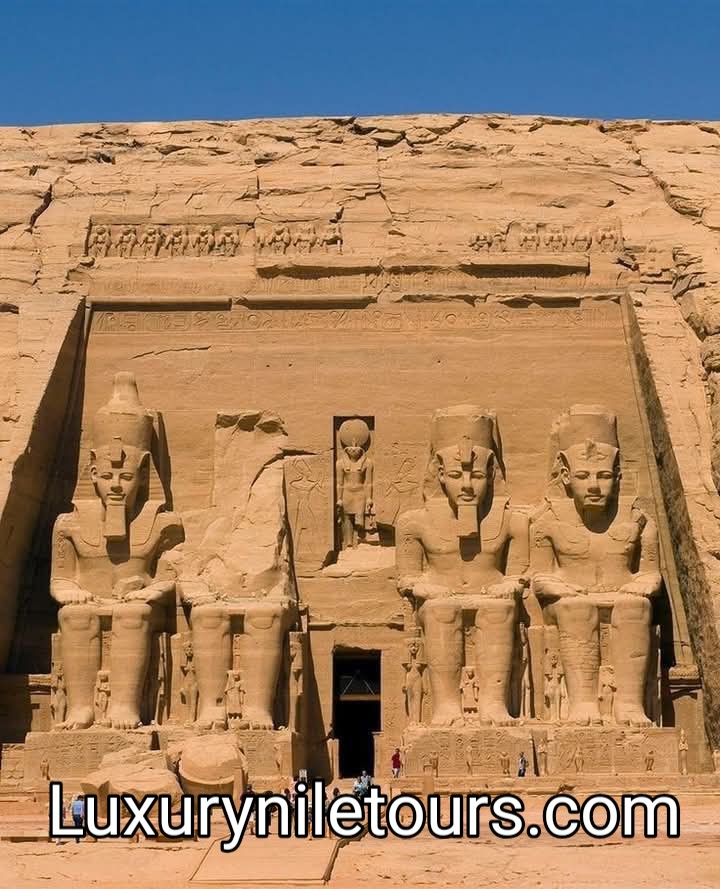 The Great Temple of Ramses II at Abu Simbel, featuring four colossal seated statues carved into a rock cliff in Nubia, Egypt.