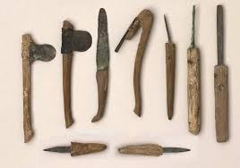 A collection of ancient embalming tools used in funerary practices, including scalpels, hooks, and probes for preparing the body.