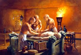 Depiction of the ancient Egyptian mummification process, with embalmers preparing a body and canopic jars for organ storage.