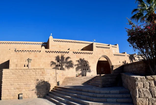 Exterior of the Nubian Museum in Aswan, Egypt, featuring traditional Nubian architectural design in sandstone and pink granite.