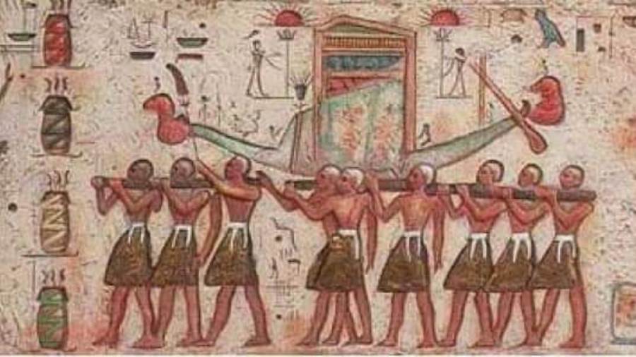 "Ancient Egyptian relief showing the Opet Festival procession with sacred barks carried by priests."