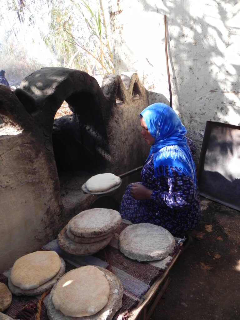 "A woman in Upper Egypt preparing traditional Eish Shamsi, or Sun Bread, a sourdough loaf left to rise in the sun before baking in a clay oven."