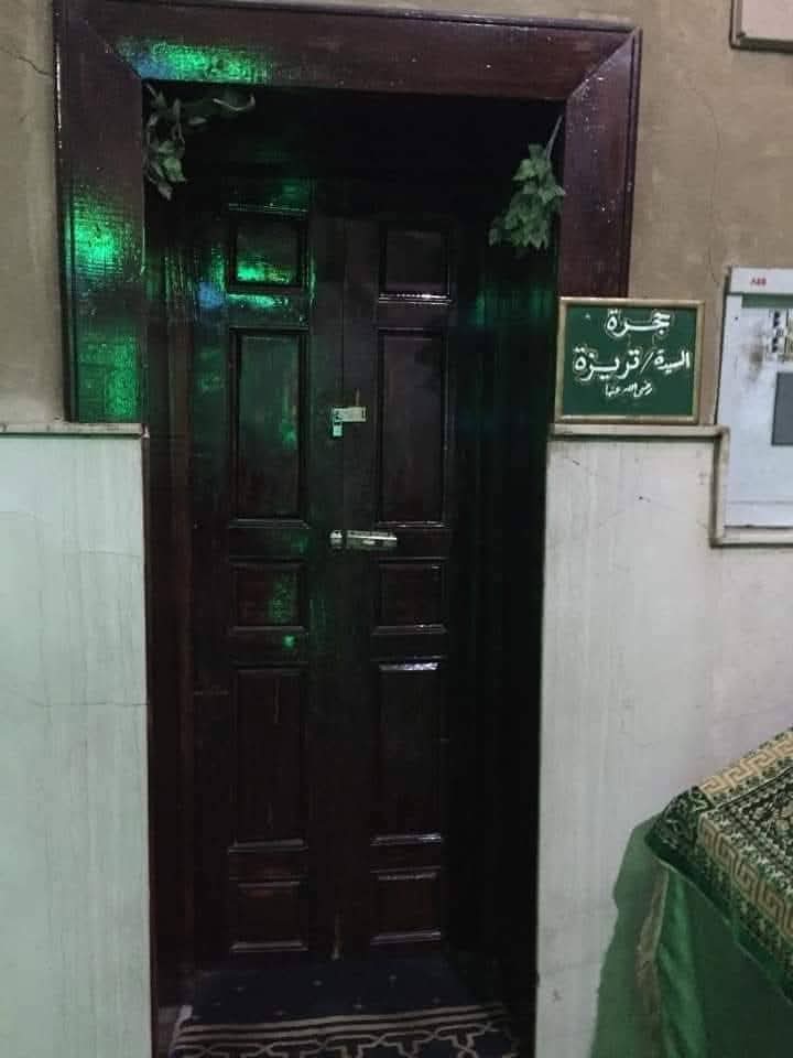 "Wooden door with a green Arabic sign reading 'Jar of Lady Teresa, may God be pleased with her,' part of a shrine linked to a Christian woman who lived in Luxor’s early Islamic period.".And afterwards believed in Islam